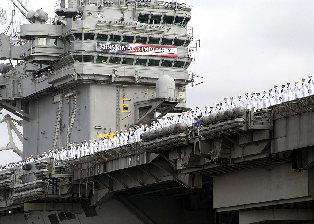 Sailors aboard USS Abraham Lincoln man the rail as they arrive at Naval Air Station North Island 