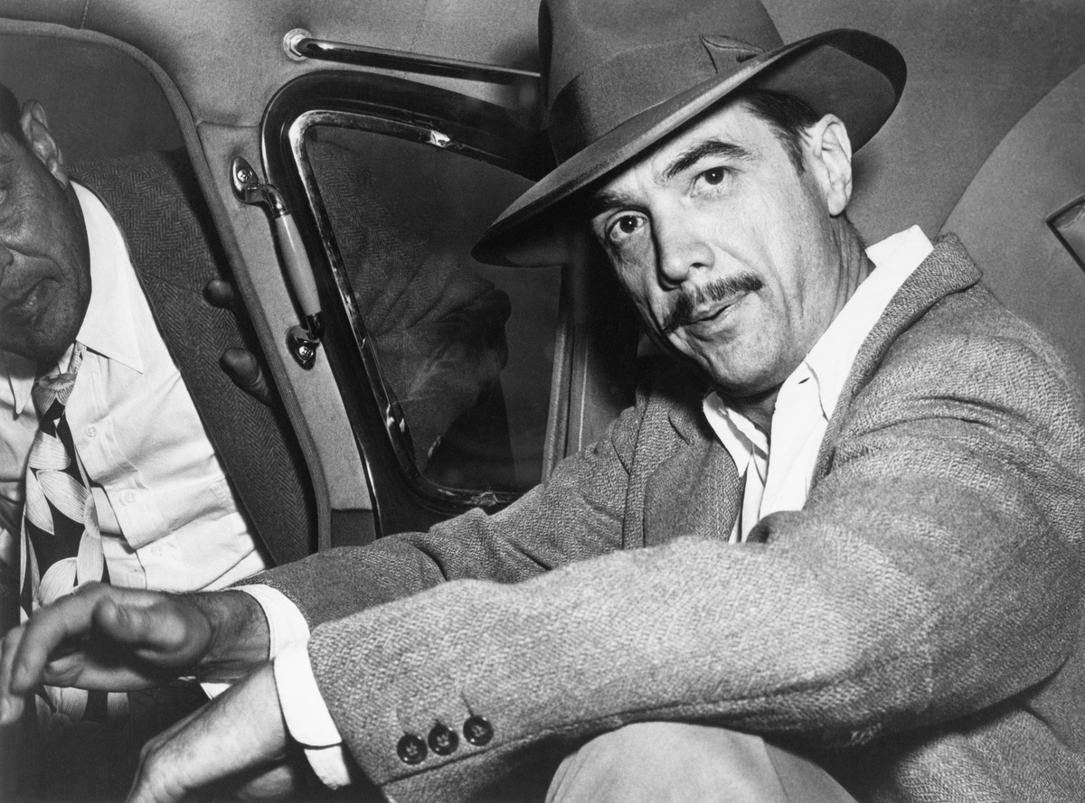 howard hughes sitting in a car in 1940.
