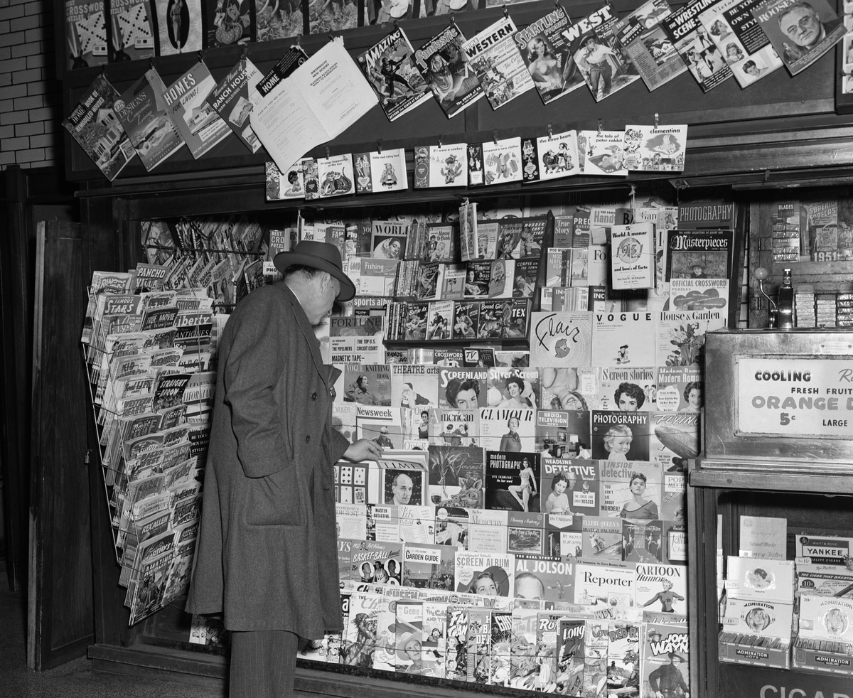 1950s NEWSSTAND WITH MAN BUYING MAGAZINE