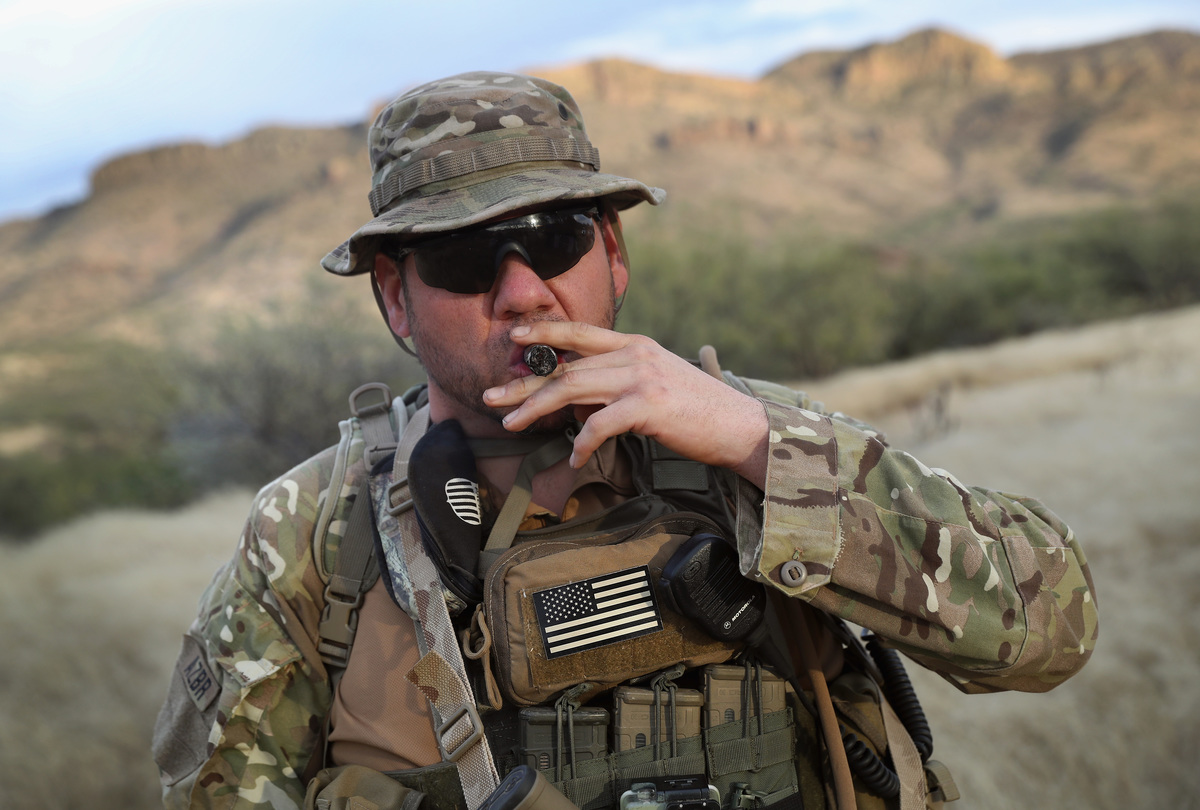 Michael LeMarte, 46, smokes a cigar after a patrol for Arizona Border Recon