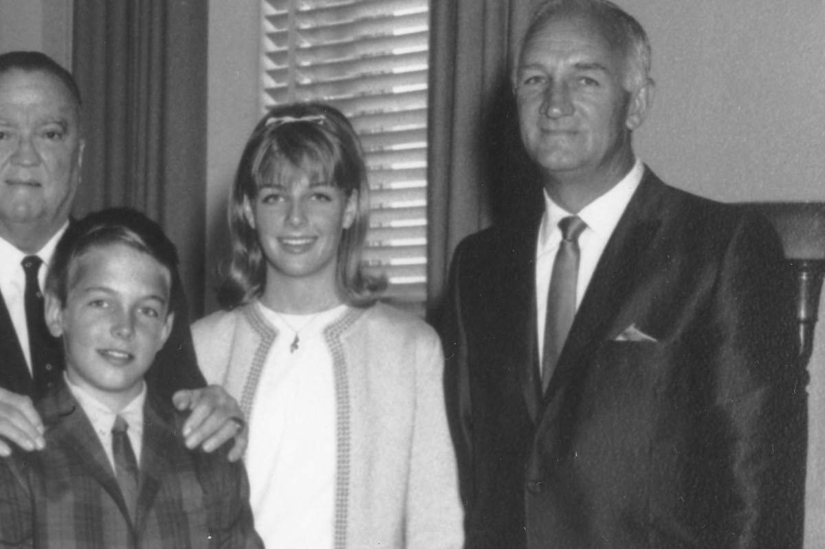 j edgar hoover puts his hands on the shoulders of mark harmon, here with his older sister kelly and father tom harmon