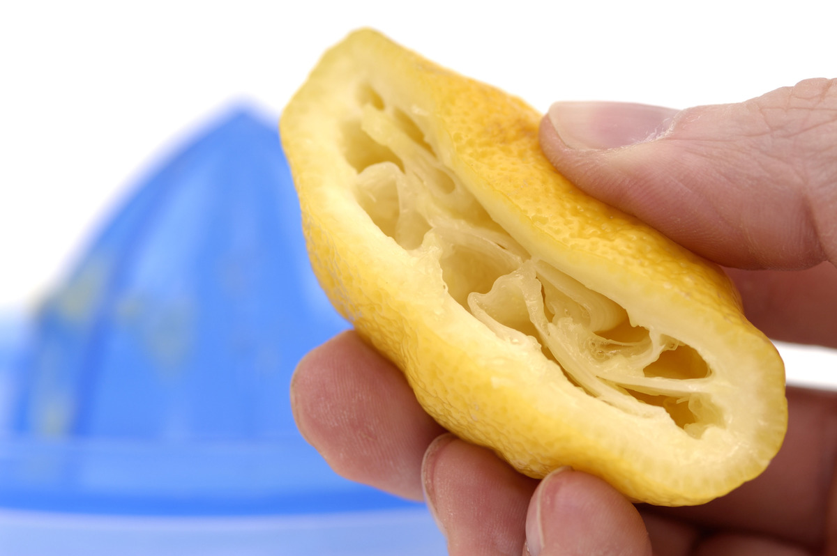 Person juicing a lemon