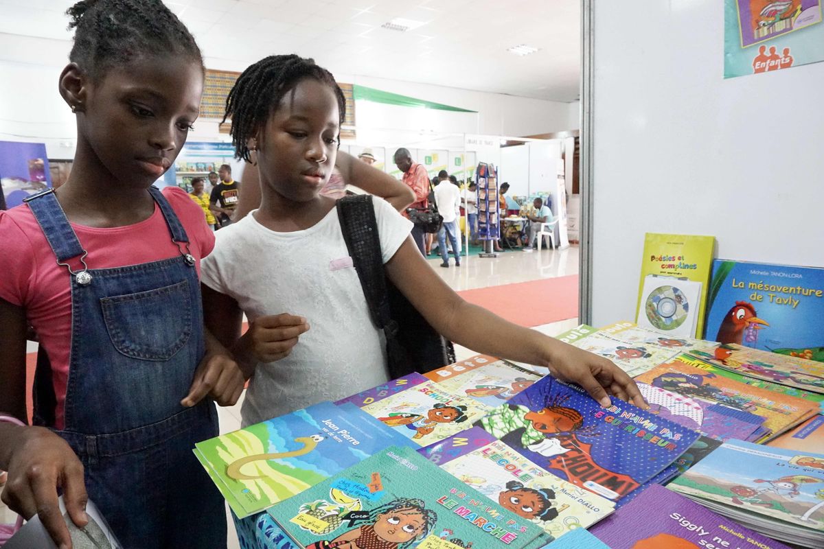 Children look at books during the newspaper cartoon and comic books festival Coco Bulles
