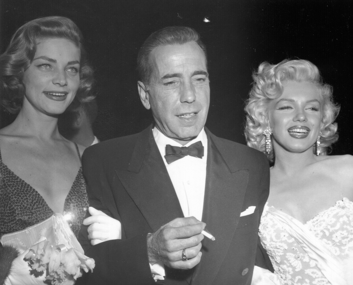 Actors Marilyn Monroe and Humphrey Bogart and Lauren Bacall attend the premiere of her movie 