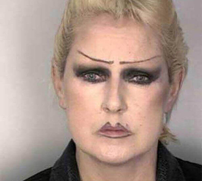 mugshot of a woman with sad eyebrows