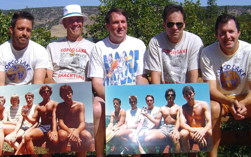the five friends holding prints of their older photos