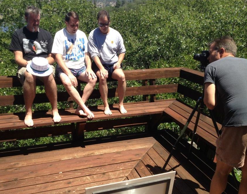 the friends using a digital camera to take their traditional photo