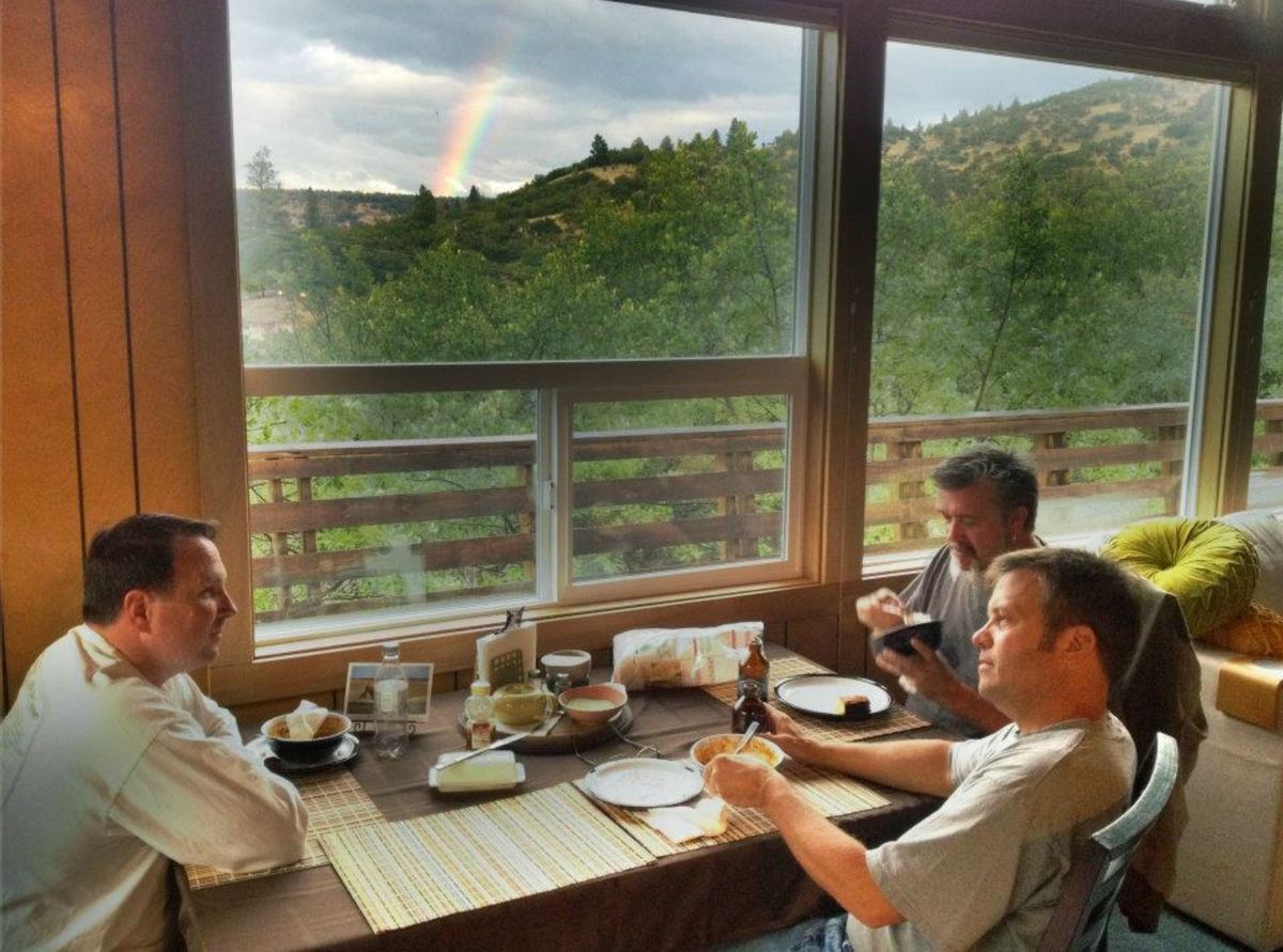 three of the five friends sitting around in their Lake Copco cabin