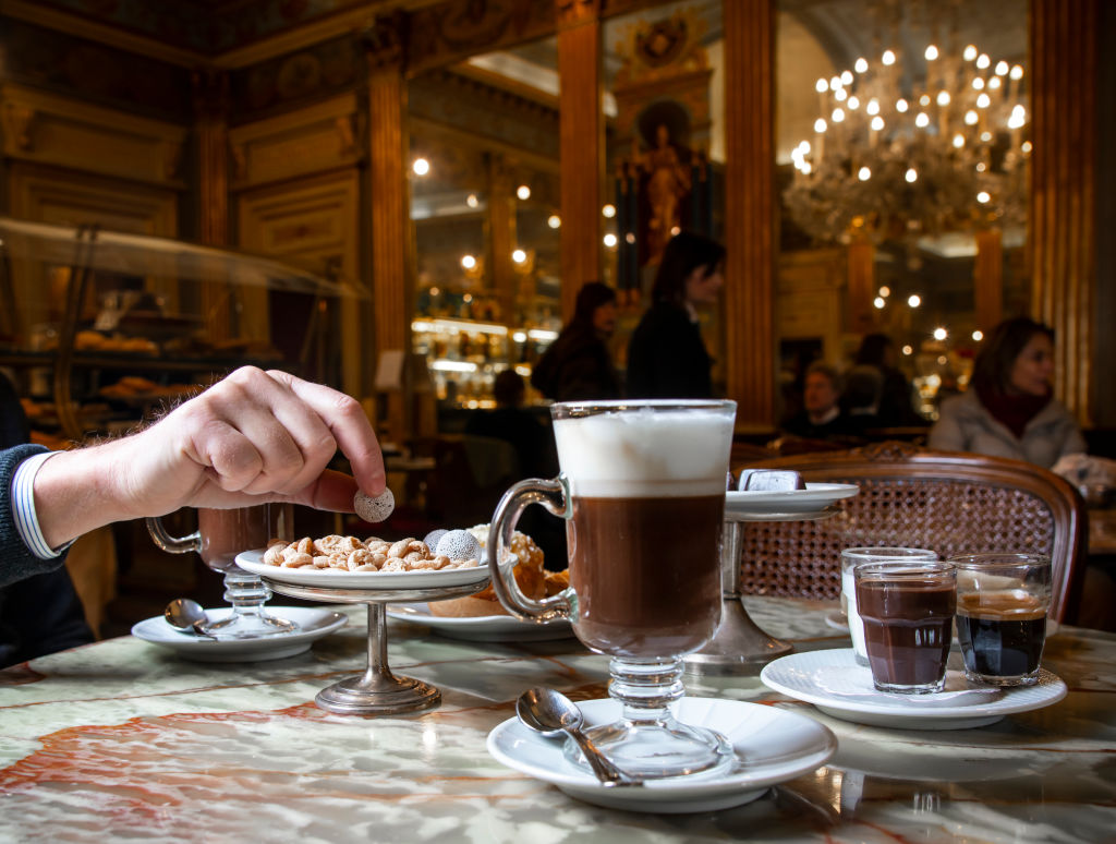A diner enjoys hot chocolate in an elegant restaurant.