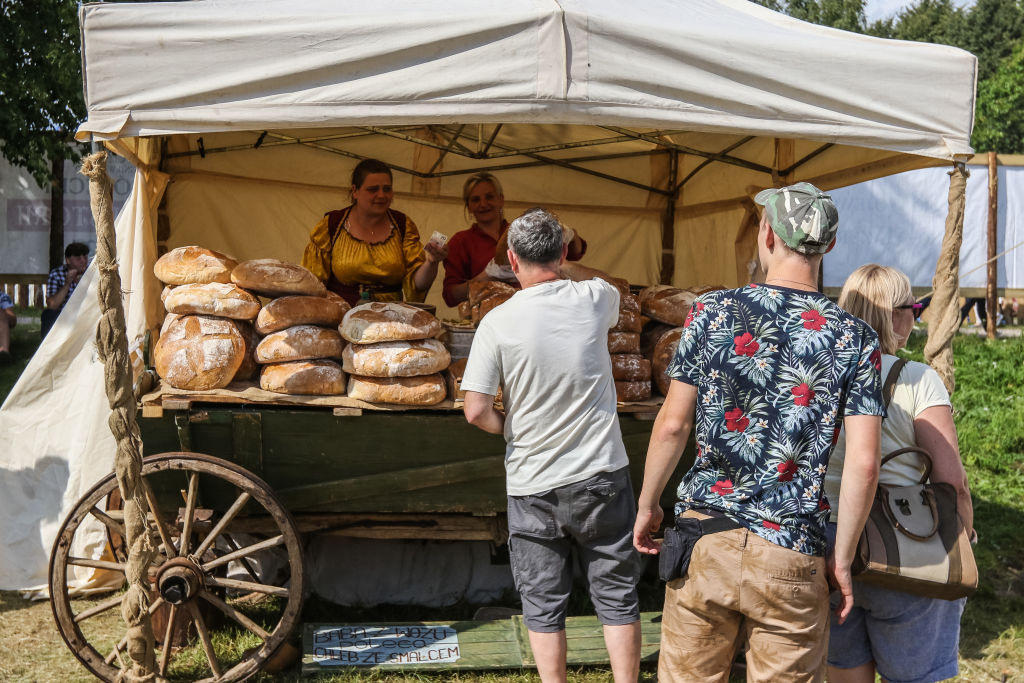 People wait in line at a bread stand.