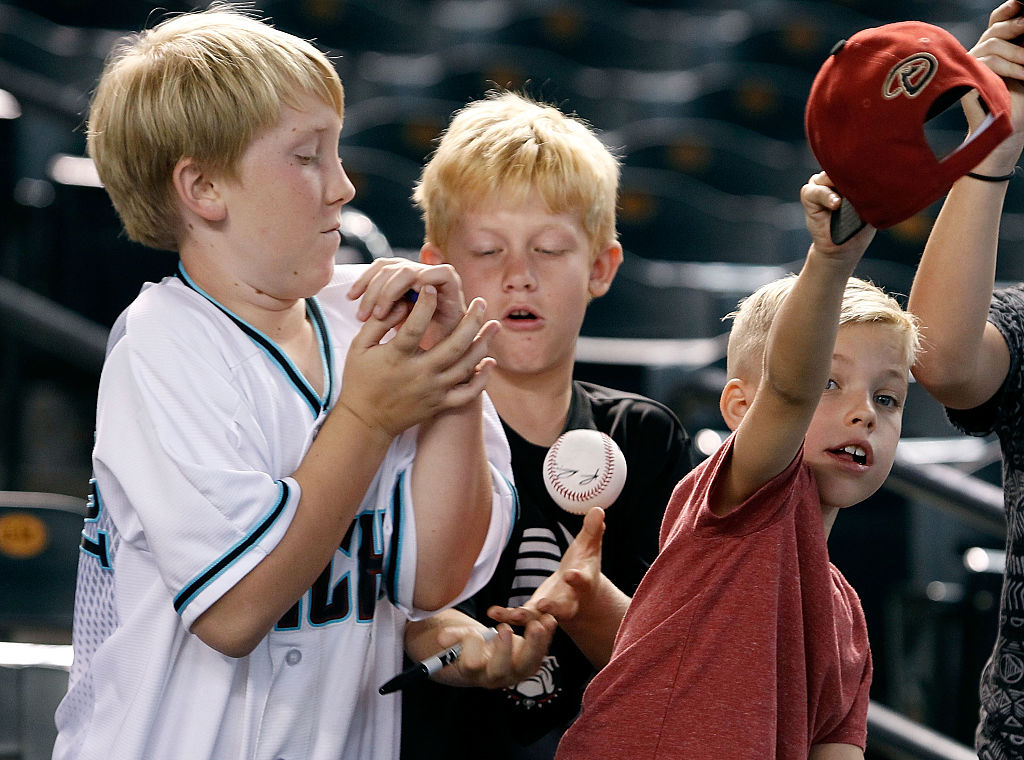 Boys trying to catch a ball 