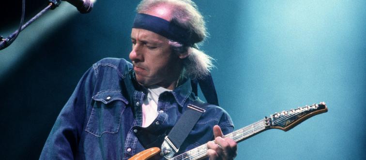 a photo of mark knopfler performing-94103616