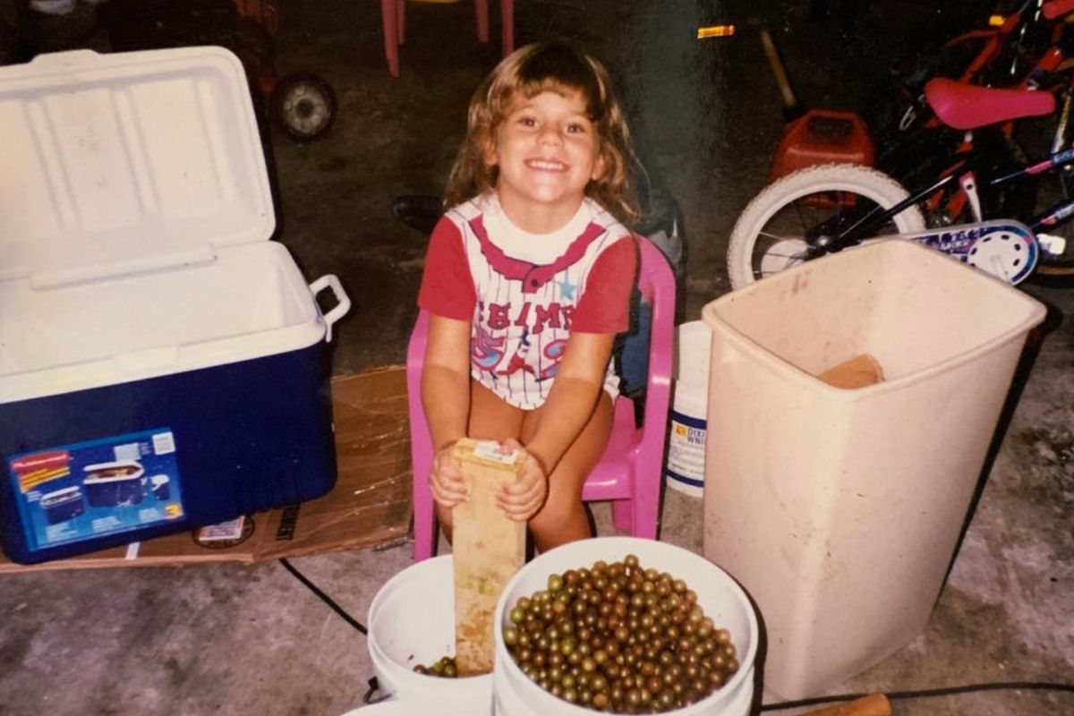 kid helping father make wine