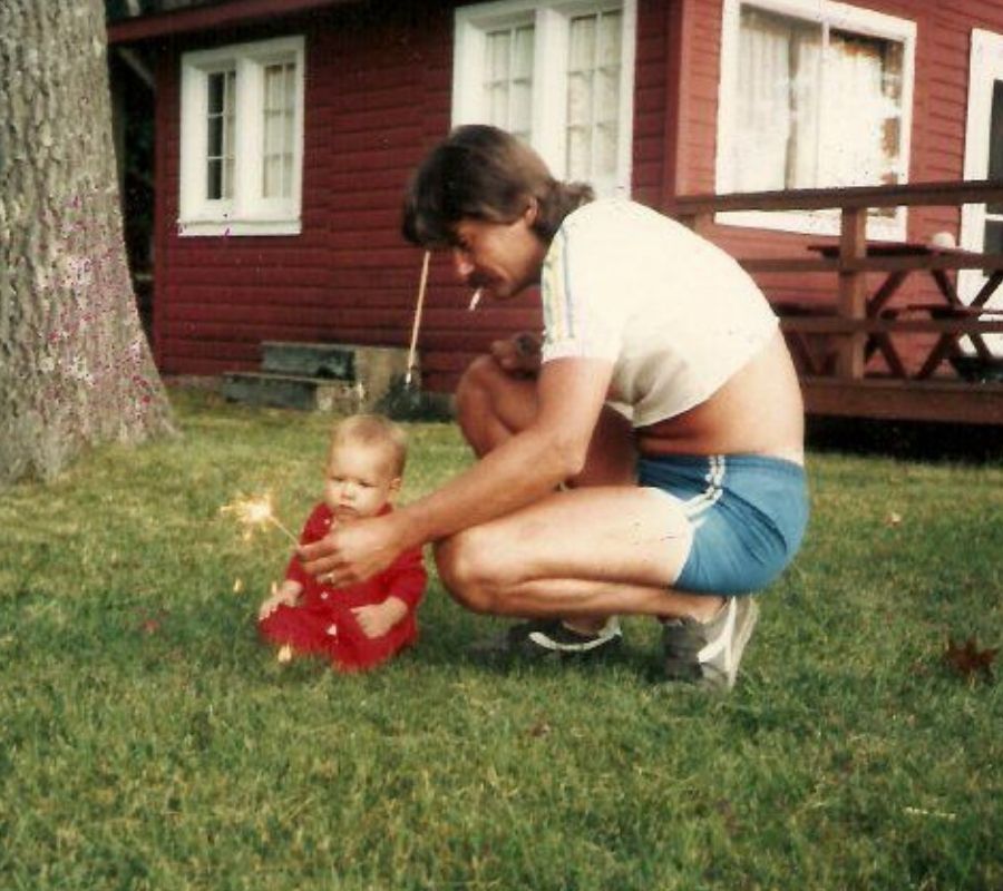 dad giving baby firework 