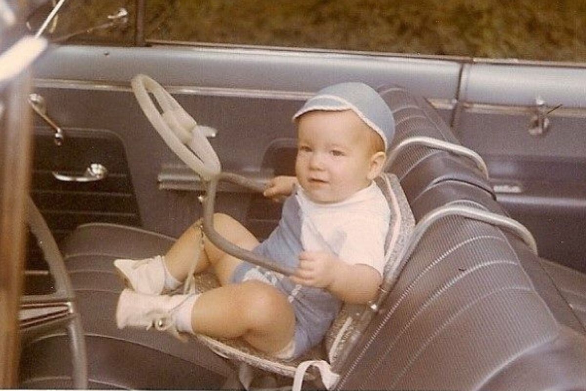 baby in a car seat looking stressed out 