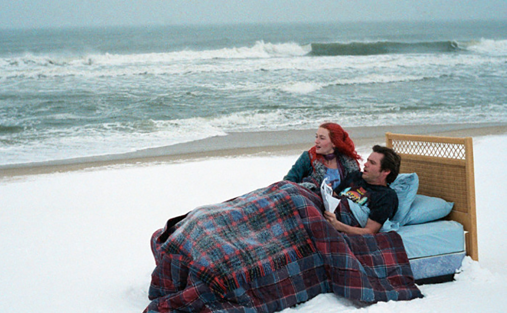 Eternal Sunshine of the Spotless Mind Sitting on a bed on the beach