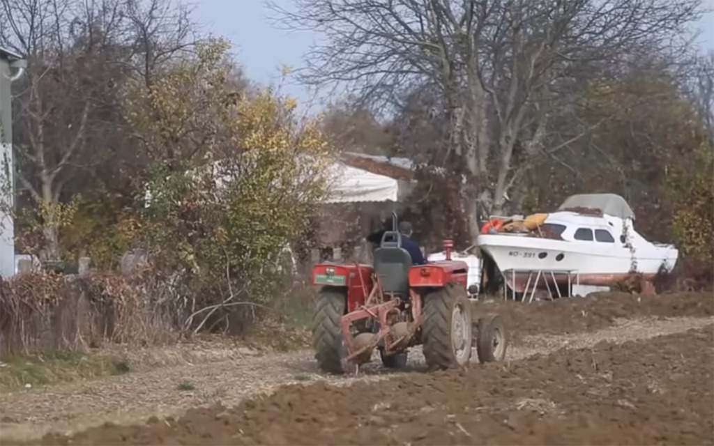 Driving away in his tractor 