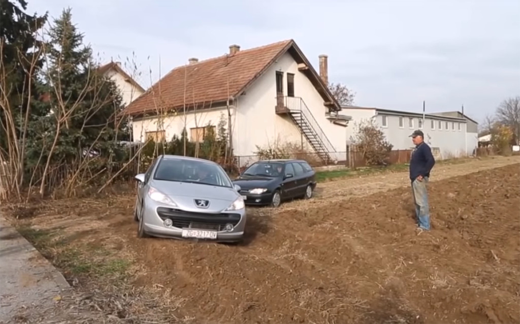 Man looking at stuck vehicle 