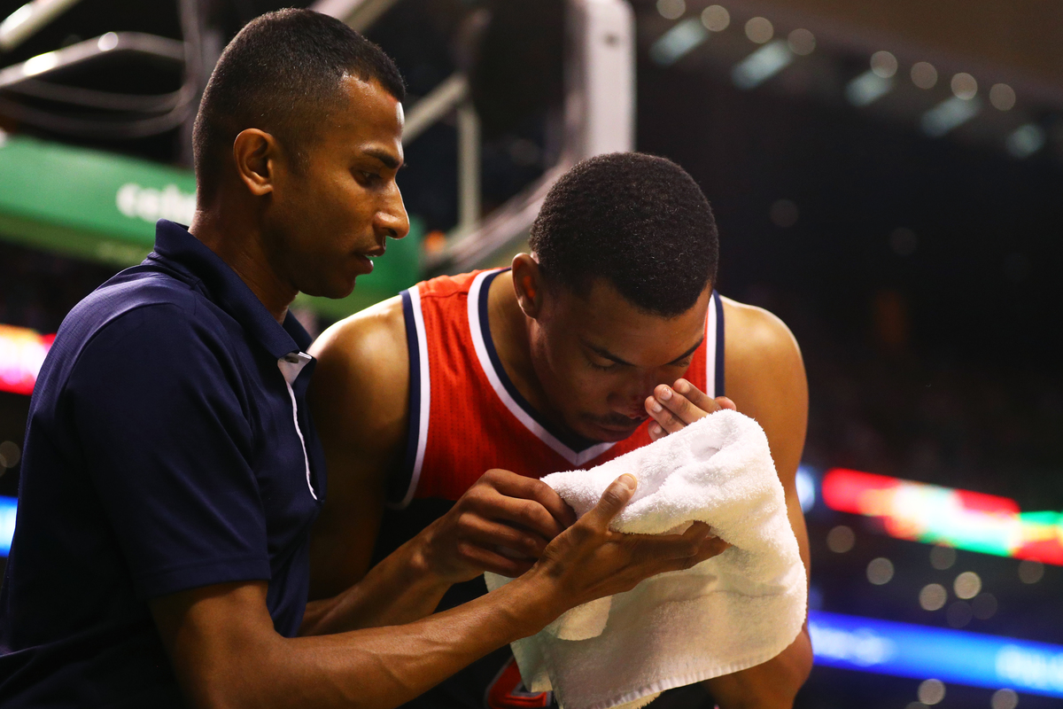 Otto Porter Jr. #22 of the Washington Wizards is tended to after getting a bloody nose
