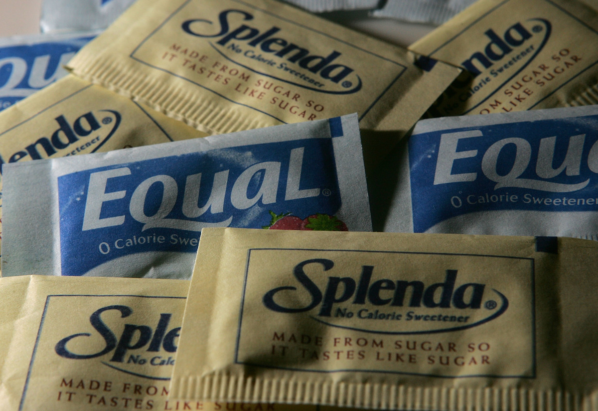 Packages of Equal and Splenda artificial sweeteners are displayed at a coffee shop