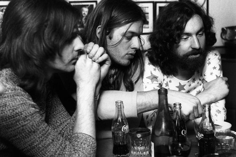 Pink Floyd sitting at a table 