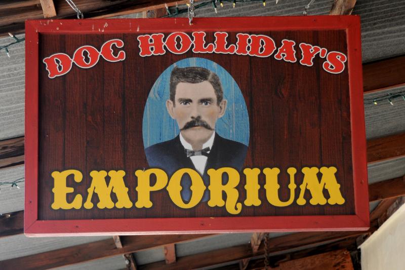 Doc Holliday Emporium - 492034909 A sign hangs over the entrance to Doc Holliday's Emporium in historic Tombstone, Arizona, known as 'The Town Too Tough to Die.'