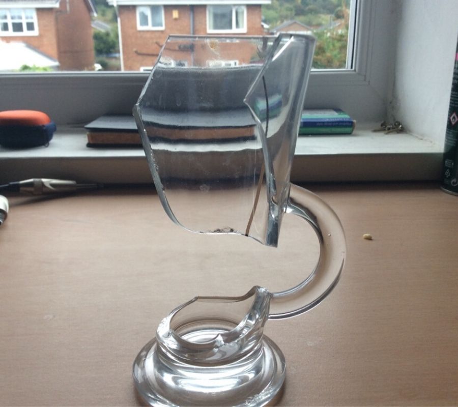 a glass mug that broken in a way that kept the handle in tact