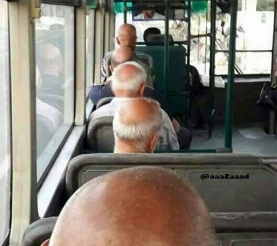 a line of bald people sitting on a bus