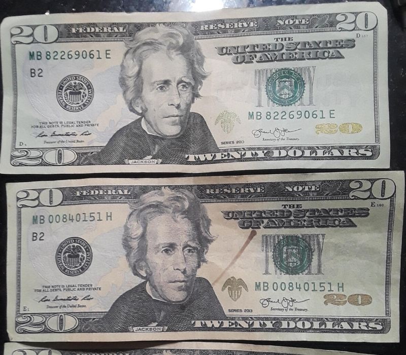 two $20 bills one real one fake
