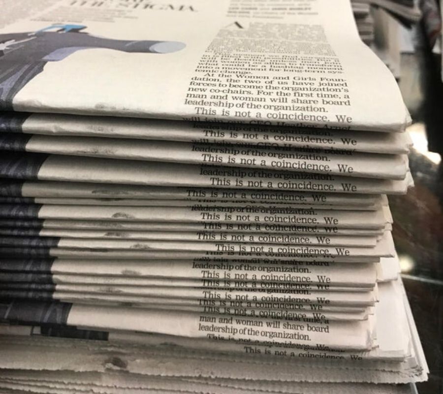 newspaper stacked perfectly to read 'this is not a coincidence'