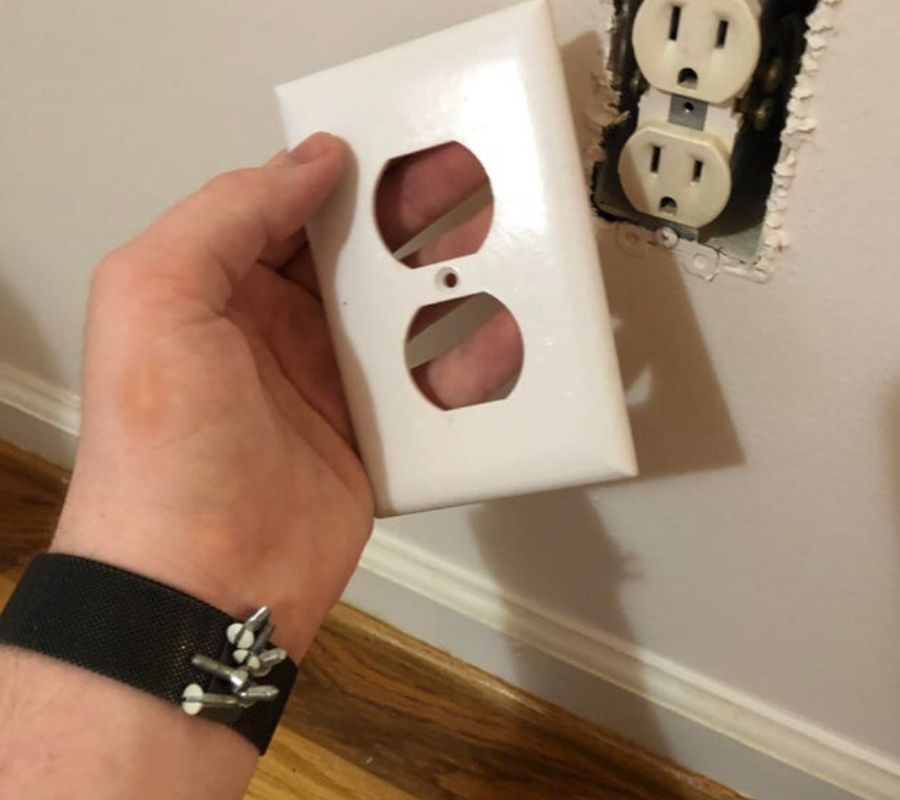 someone wearing a magnetic strap on their wrist to hold onto screws