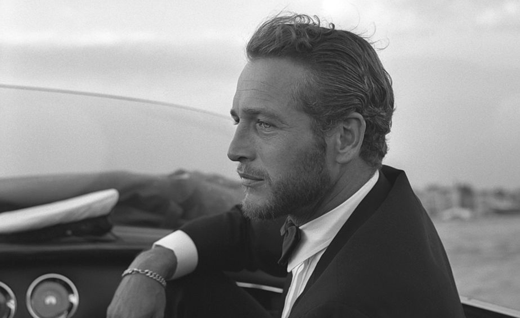 Newman sitting in a taxi 