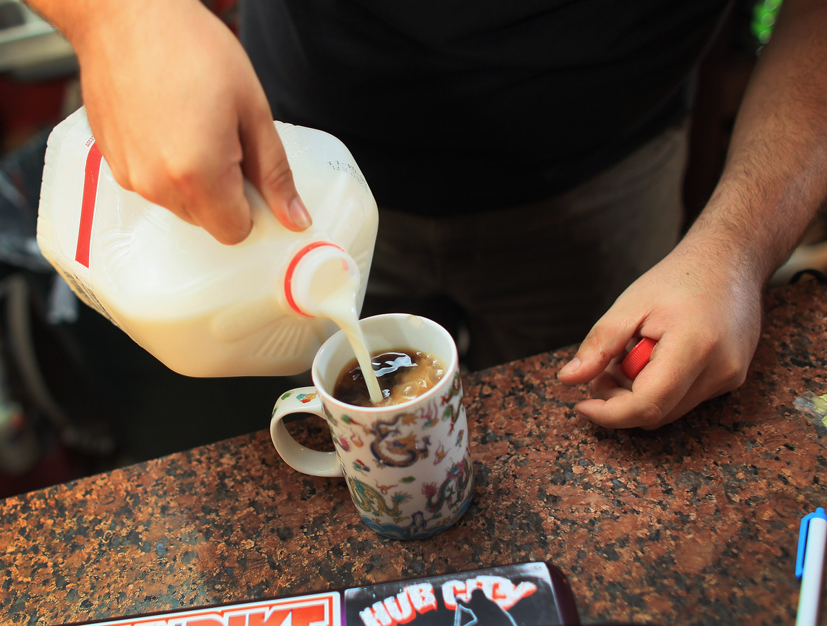 pouring milk in coffee - 115538896 Kyle Kaly adds milk to his cup of coffee at the Undergrounds Coffeehaus.