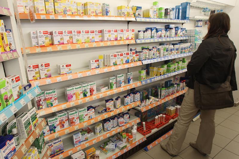 browsing supplements - 146519211 A shopper looks among health supplements at a drugstore.