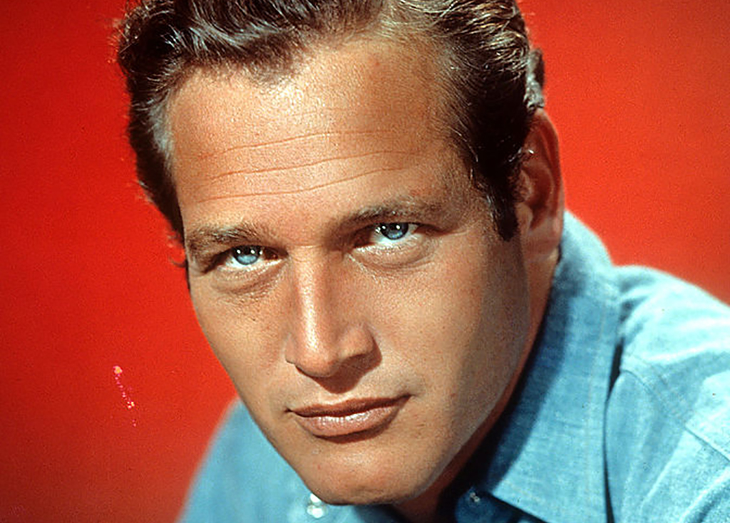 Newman's blue eyes posing in front of a red background