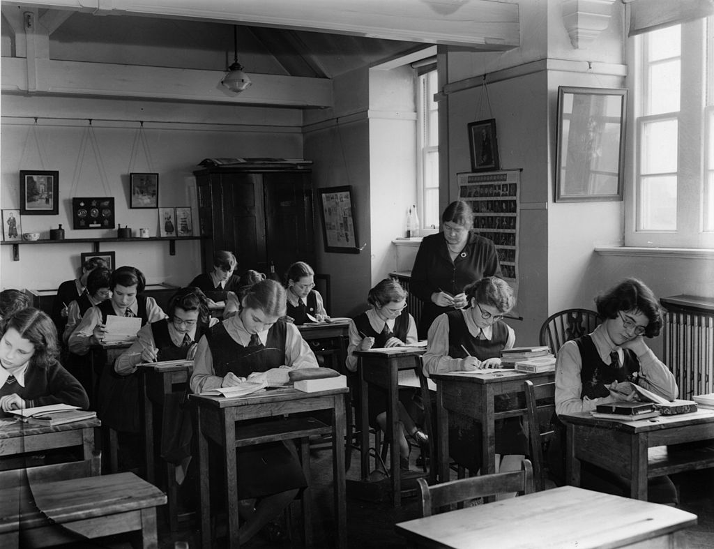 Girls do work in the classroom of a boarding school.