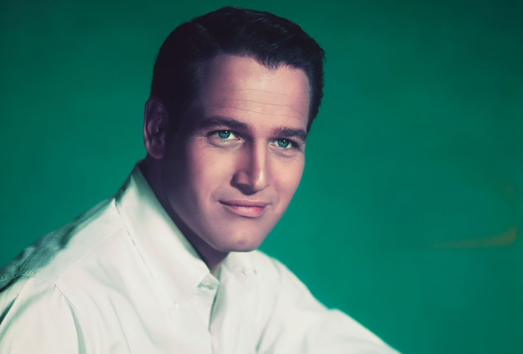Paul Newman posing in front of green background 