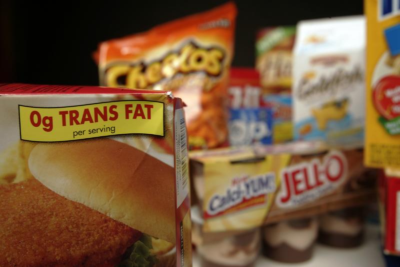 trans fats on labels - 564051847 Food packages labeled with trans fats are shown.