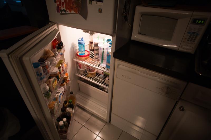 opened fridge - 566354143 A refrigerator is open at night.