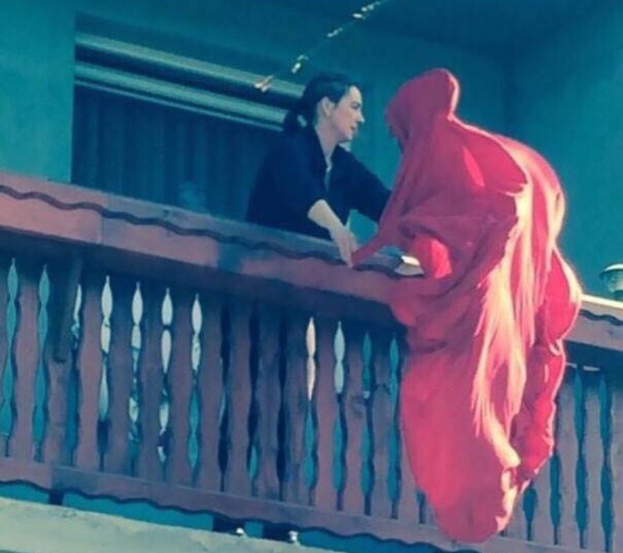 ghost  a woman shaking out a sheet makes it look like a ghost