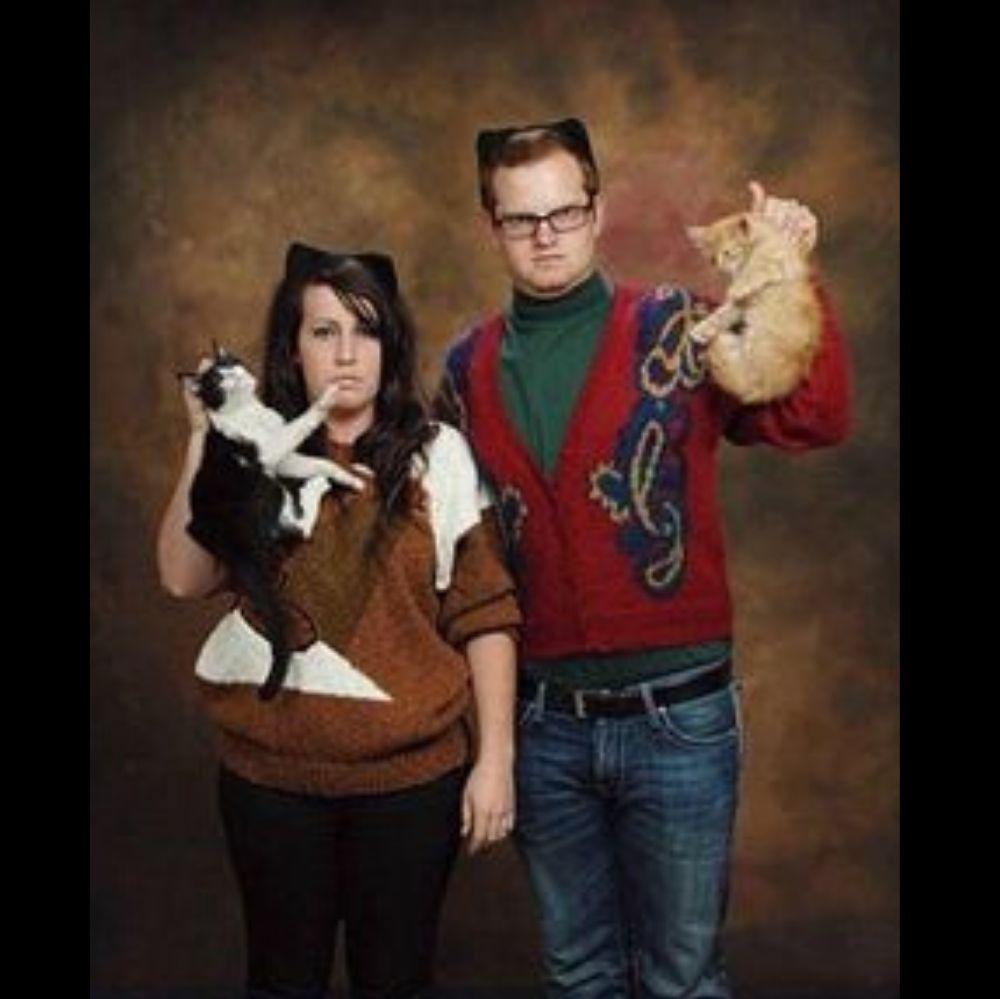 meow couple hold cats by the neck and look angry