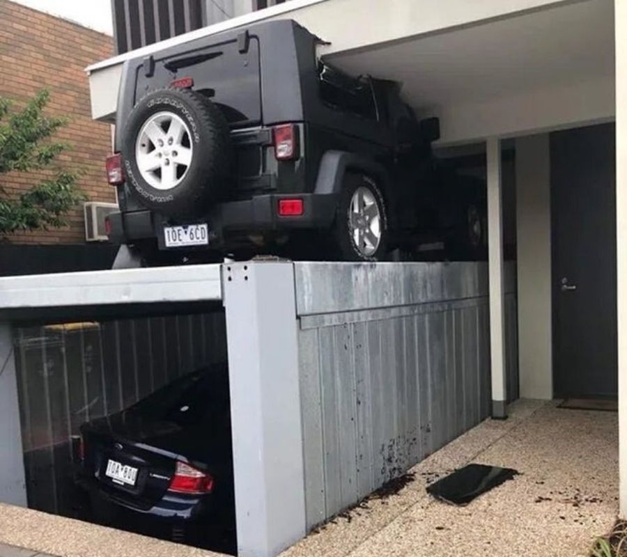 a person opened their underground garage while forgetting their other car was on top