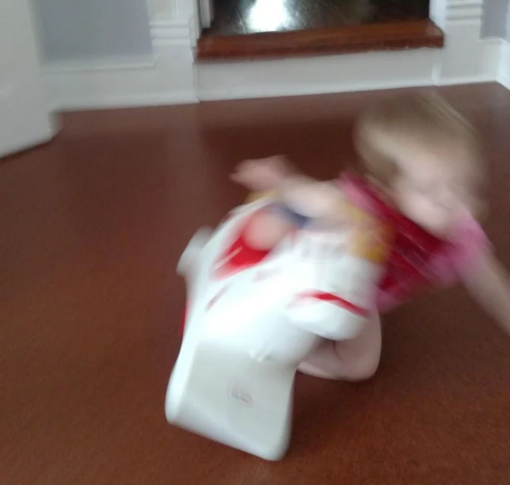 Blurry Photo of kids falling off toy horse