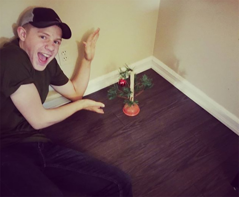 A small piece of a Christmas tree is fixed to a plunger.