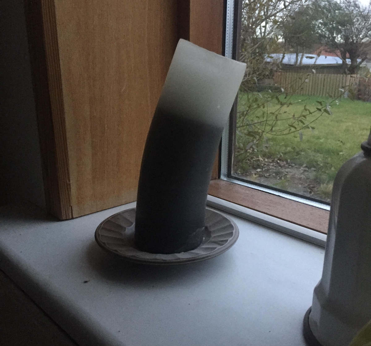 candle that has been warped from sitting in the sun
