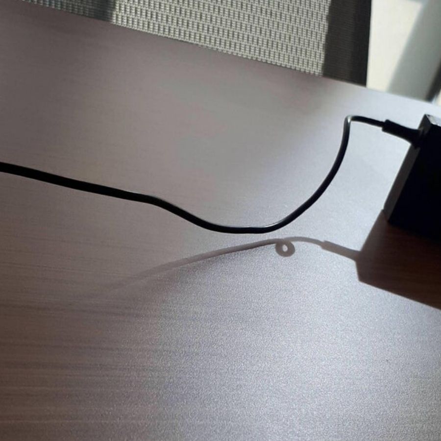 electrical cord that looks straight but the shadow in twisted