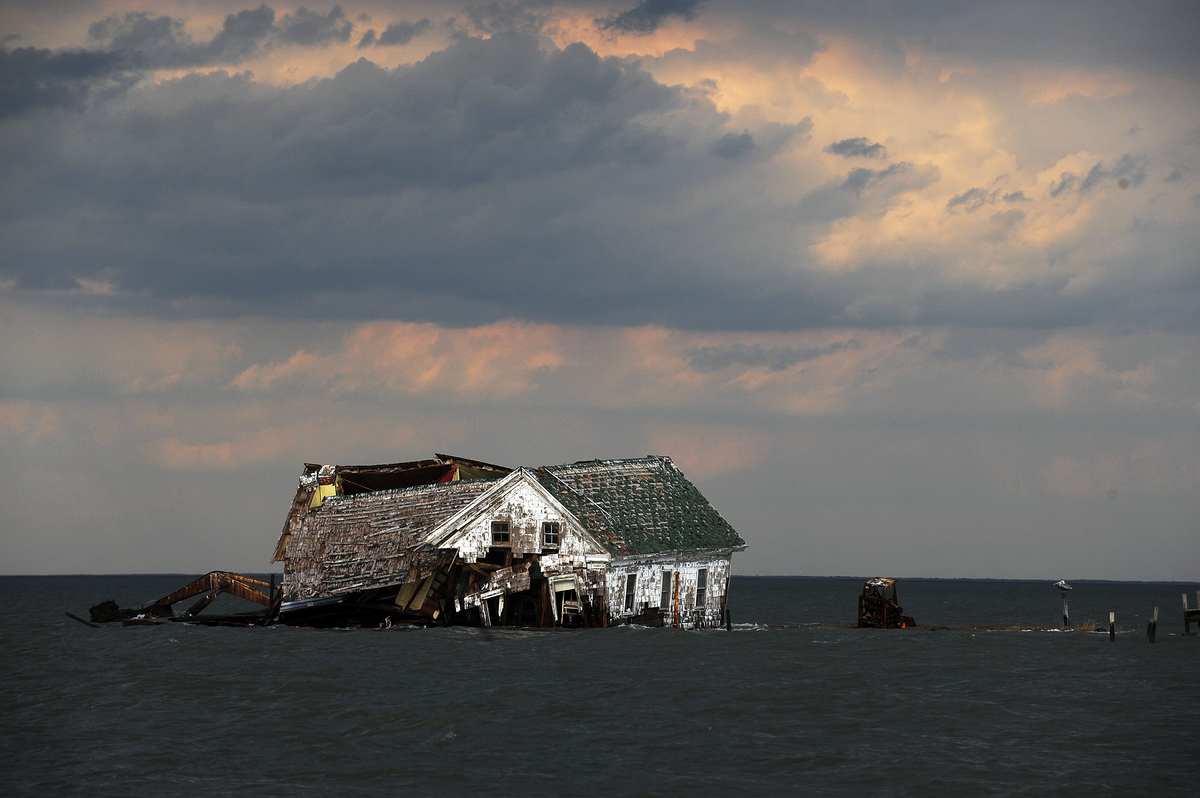 The last house on Holland Island collapses from erosion.
