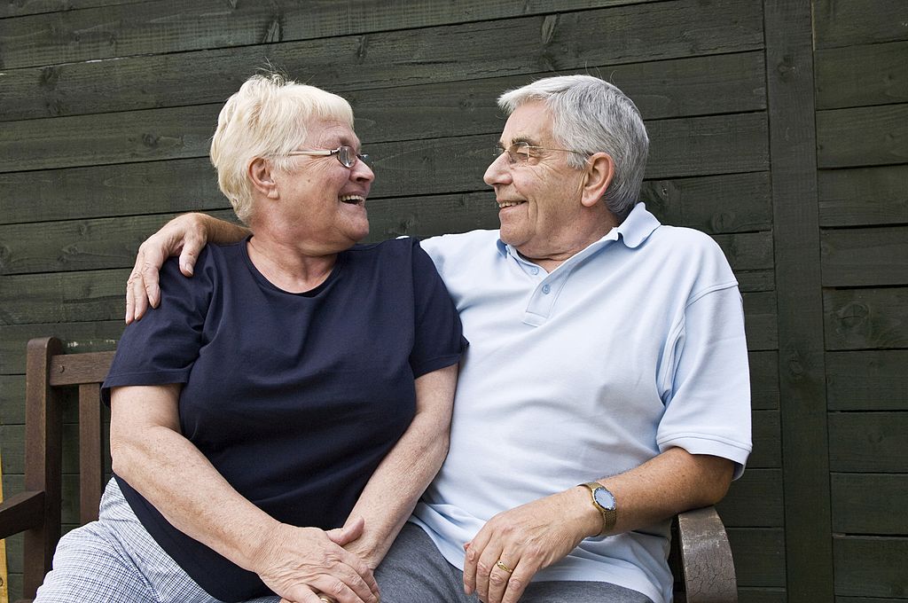 smiling-senior-couple An older couple smiles at one another.