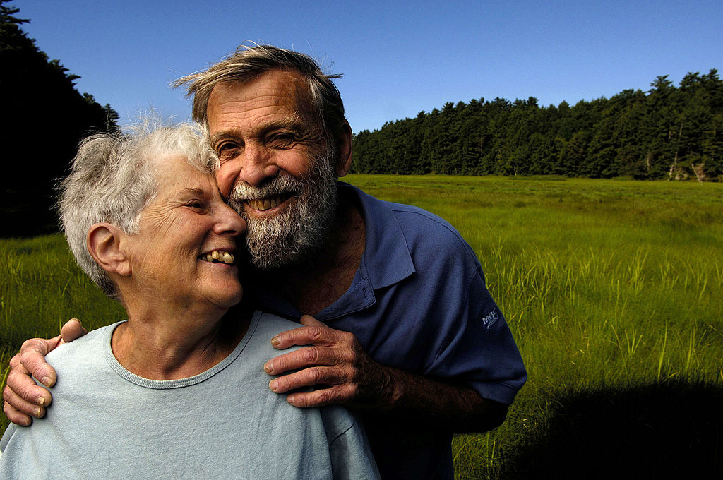 happy-couple An elderly couple smiles and pose close together.