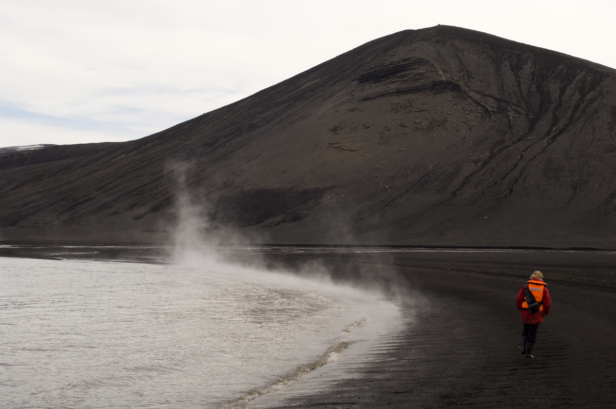 A man walks down Deception Island in Antarctica. 